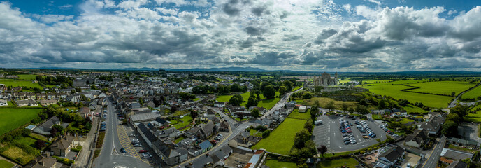 Aerial panorama of Cashel town , Rock of Cashel iconic Irish historic landmark with Romanesque chapel, a Gothic cathedral, an abbey, the Hall of the Vicars Choral and a fifteenth-century Tower House