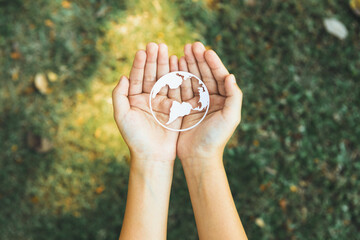 Top view hand holding Earth planet icon symbolize eco-friendly commitment to environmental protection and zero carbon emission. Earth World Day concept to promote eco awareness. Gyre