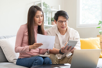 financial in family concept, Happy Asian husband and wife calculating income and bills to plan for investment.
