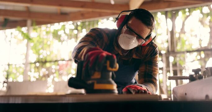 Construction, carpenter and handyman with wood project in workshop at home for renovation and maintenance. Contractor, machine an person with ppe and bokeh in workplace at house for for carpentry