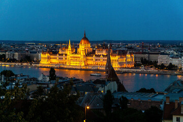 View of illuminated Parliament building from fishermen bastion on Buda side across river Danube in Budapest, Hungary.