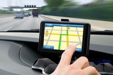 Person's Hand Using Gps Navigation System In Car