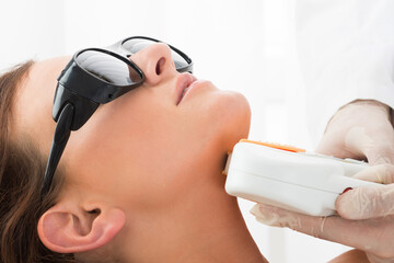 Woman Receiving Laser Hair Removal On Neck
