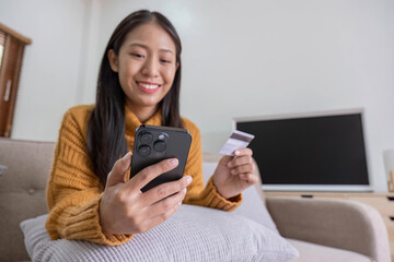 Ecommerce, hands or woman with credit card or phone for a digital payment on sofa relaxing at home. Smile, finance or happy girl online shopping for subscription sales offer, banking or fintech deal