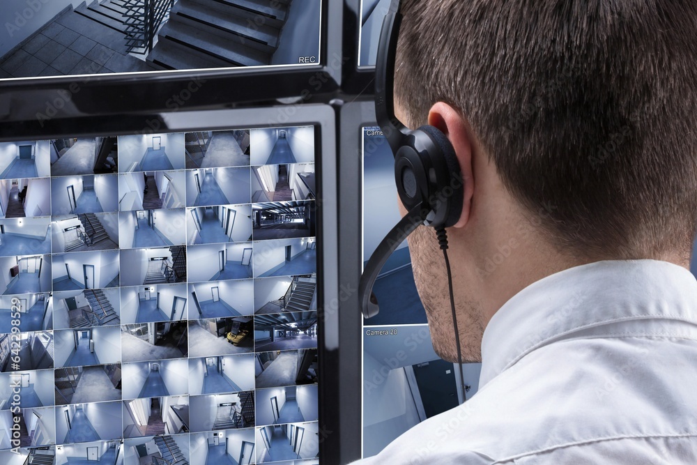 Aufkleber Operator Looking At Multiple Camera Footage On Computer