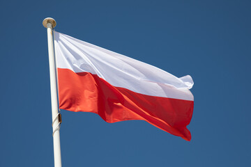 poland polish flag mat red white colors of Republic of Poland wave over a blue sky