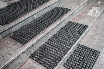 Rubber mats on the porch steps on an autumn day