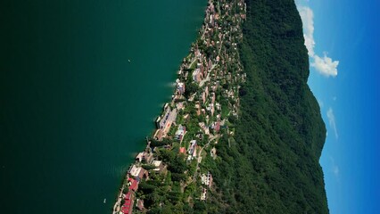 Vertical video. Lake Lugano between italy and switzerland, deep blue lake, day off, yachts on the water, beautiful view, drone footage - Powered by Adobe