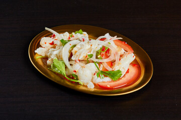 Spicy chicken feet salad, serve on gold stainless dish