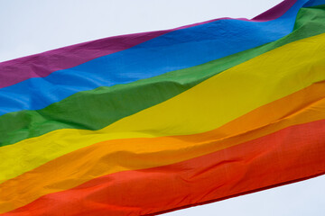 A rainbow flag with sky background. LGBTQ Freedom homosexual.