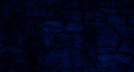 Abstract black and blue background - stone wall from big old stones
