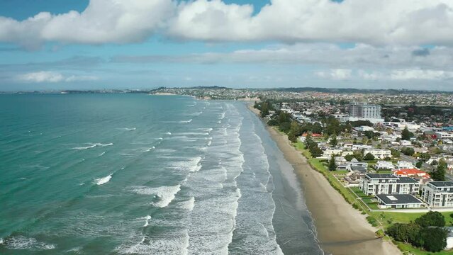 Aerial View from the Beach, Green Trees, City Streets, and Waves of Orewa in New Zealand - Auckland Area	