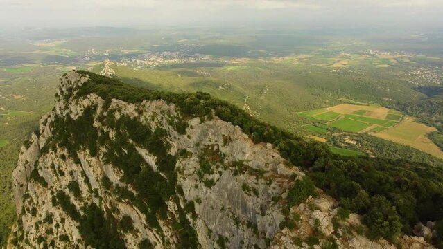 Aerial view of the Pic Saint Loup, a rocky hill near Montpellier, France. Spectacular cliffs and hazy hot summer day.