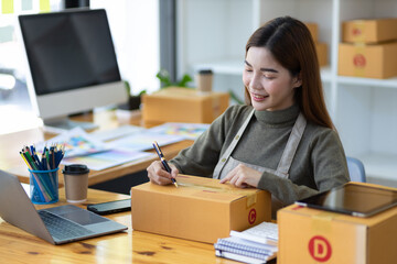 Entrepreneurs start small businesses. Woman doing online sales startup business checking internet...