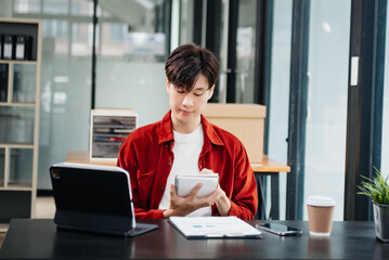 Man freelancer is working her job on computer tablet and laptop Doing accounting analysis report real estate investment data, Financial at office