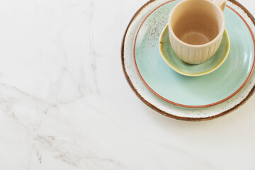 ceramic cup and plate on white marble table
