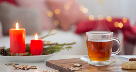 cup of tea with burning candles at home