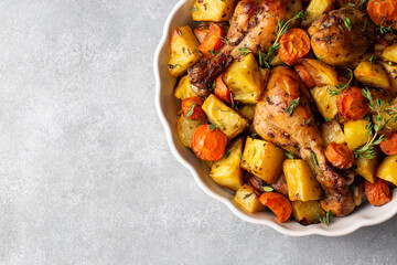 Baked chicken thighs and fried potatoes look delicious.