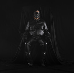 Fototapeta na wymiar portrait of a futuristic soldier in a mask on a black background