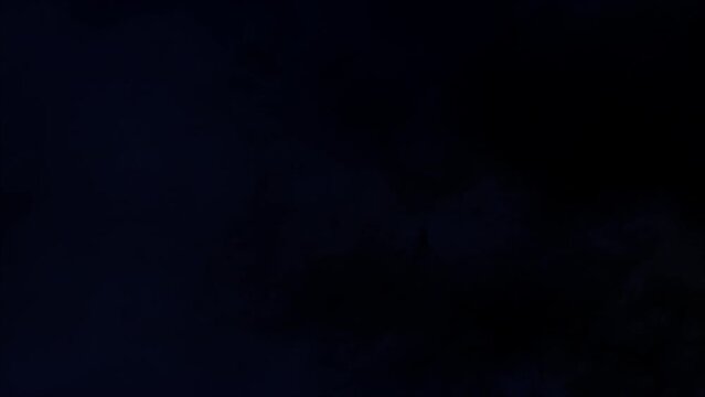Lightning discharge and light effects in the clouds. Thunderclouds in bright flashes of lightning. Bad weather. Looped
