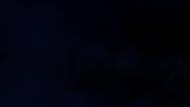 Lightning discharge and light effects in the clouds. Thunderclouds in bright flashes of lightning. Bad weather. Looped
