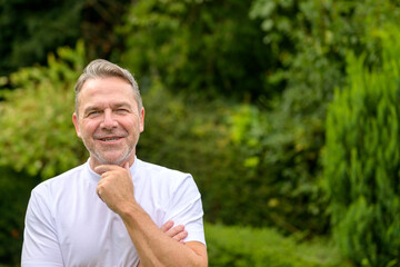 Attractive man having one hand on his chin