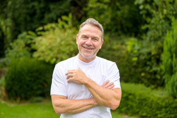 Man in his 50s having his arms crossed in front of his chest