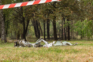 Burnt missile in public park, Kyiv, Ukraine, 2023. Aftermath of air attack on Kyiv. Russian aggression against Ukraine. War in Ukraine. Missile attack on civilians. Downed missile with barrier tape.
