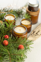 Soy candles burn in glass jars. The evening is dark. Aromatherapy and relaxation. Comfort at home. Candle in a brown jar. Scent and light. Scented handmade candle. Aroma therapy