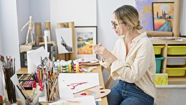 Young blonde woman artist make photo to draw smiling at art studio
