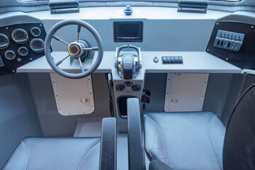 Speedboat interior. Seat and steering wheel for captain of yacht. Steering wheel and...