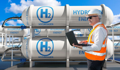 Hydrogen energy. Man is technologist in industrial factory. Liquefied hydrogen tanks. Engineer with...