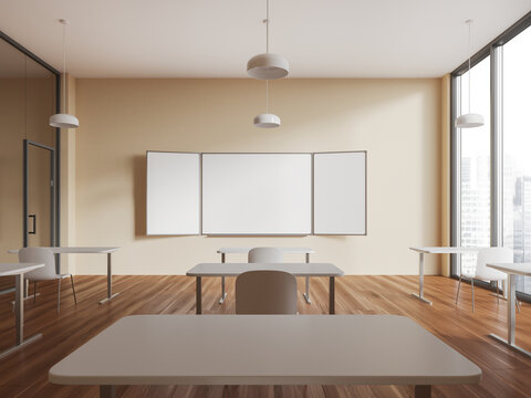 Beige stylish classroom interior with table in row and empty mockup chalkboard