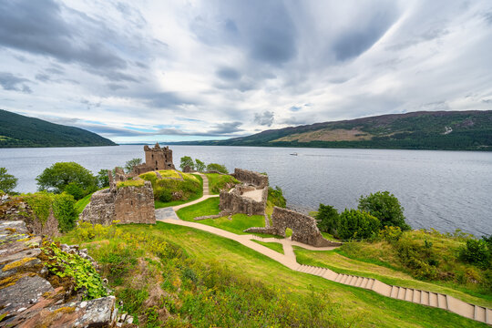 Great panorama of Loch Ness with Urquhart Castle on a hill by the loch, Scotland.
