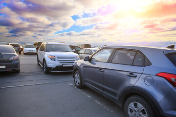 Fototapeta na wymiar Cars in the parking lot at sunset