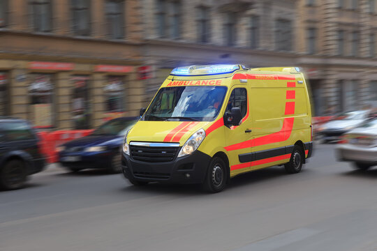 Ambulance is driving along a city street.