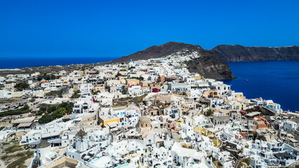 Fototapeta na wymiar Oia Santorini Greece aerial drone view with blue sea and clear sky