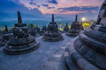 Ancient Buddhist temple during sunset evening time against orange cloudy sky