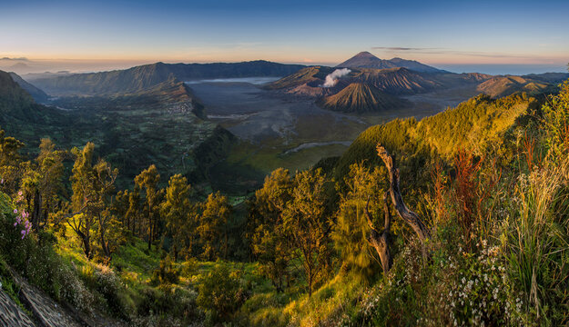 Amazing view of mountains with active volcano with smoke in evening time daylight