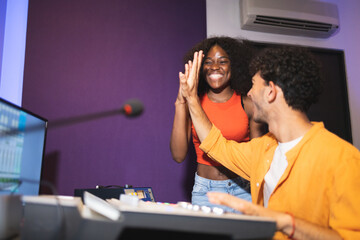 Man and black woman approving recorded sound