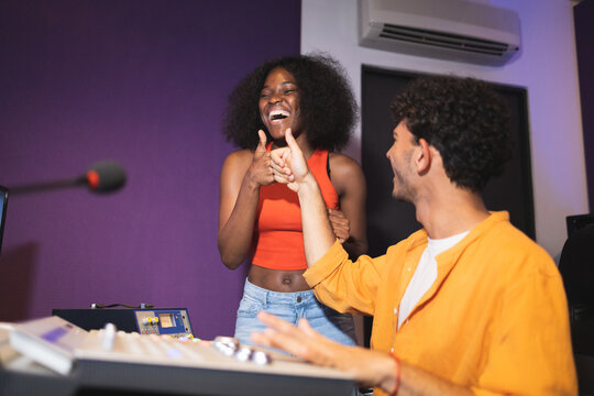 Man and black woman approving recorded sound
