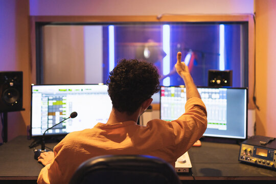 Man approving while recording vocal sound in studio