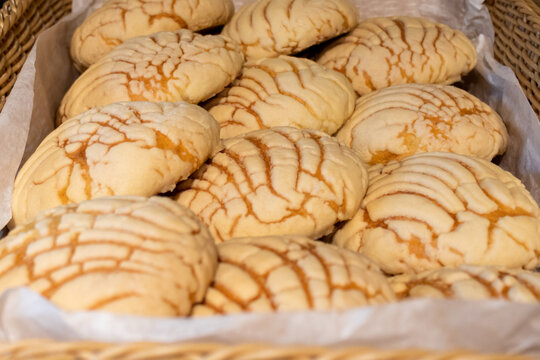 Pile of baked concha bread in basket