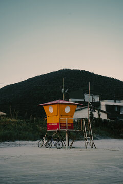Old lifeguard hut on sandy beach in evening