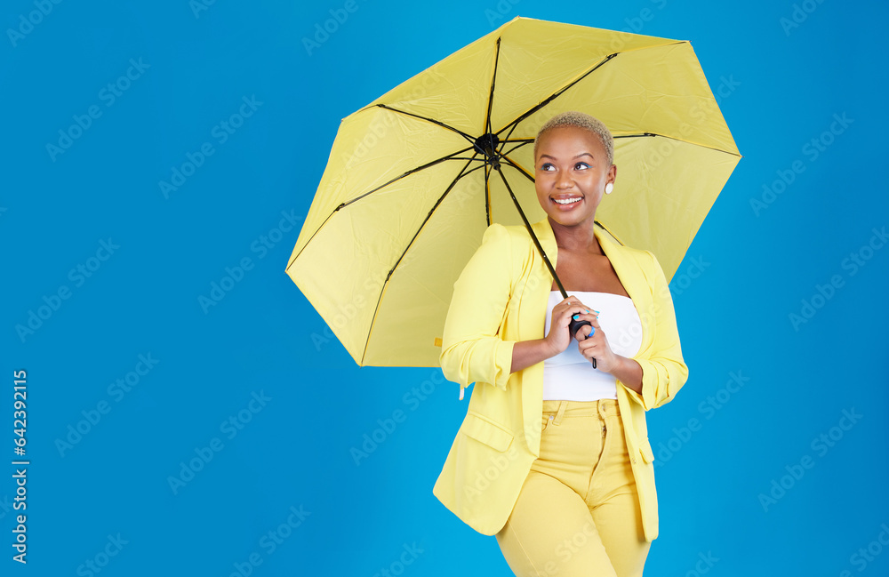 Wall mural Black woman, umbrella and face with smile in studio for life insurance and security isolated on blue background. Shield, happiness and person for fashion, style and confidence with mockup space