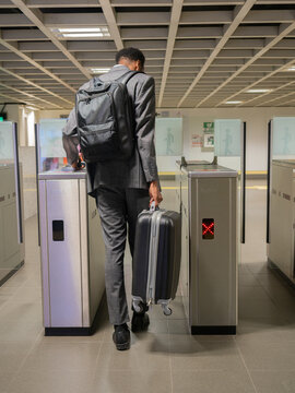 Black businessman with baggage in metro