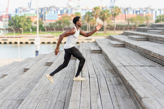 Black sportsman training on stairs