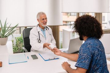 Cheerful doctor giving medicine to patient