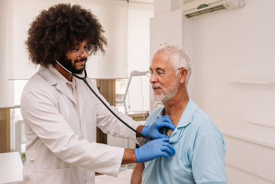 Ethnic doctor examining patient with stethoscope