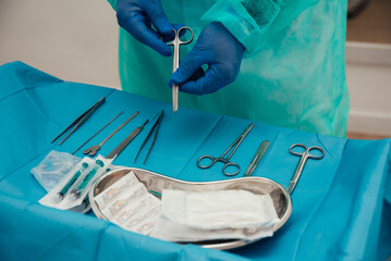 Crop doctor arranging surgical instruments on table before operation